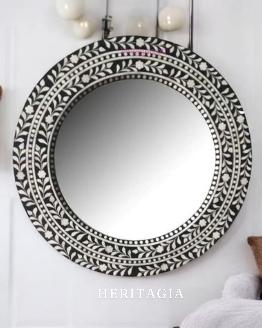 Detailed view of handcrafted black and white floral bone inlay mirror frame