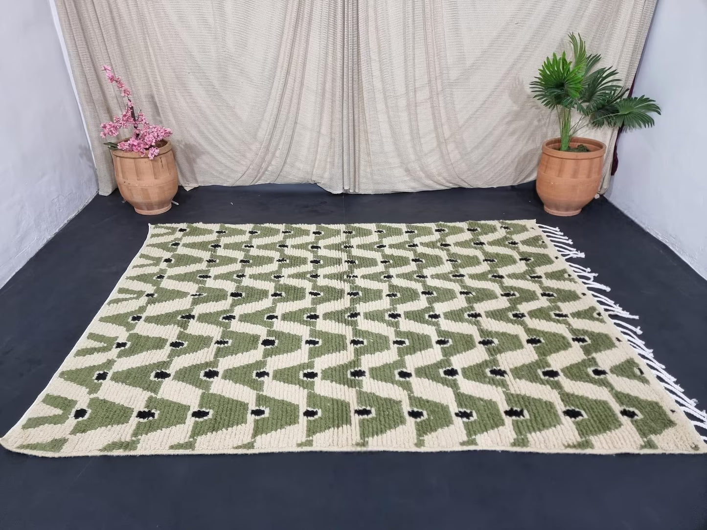 Artisan hand-knotted wool rug in green and beige with repeating pattern