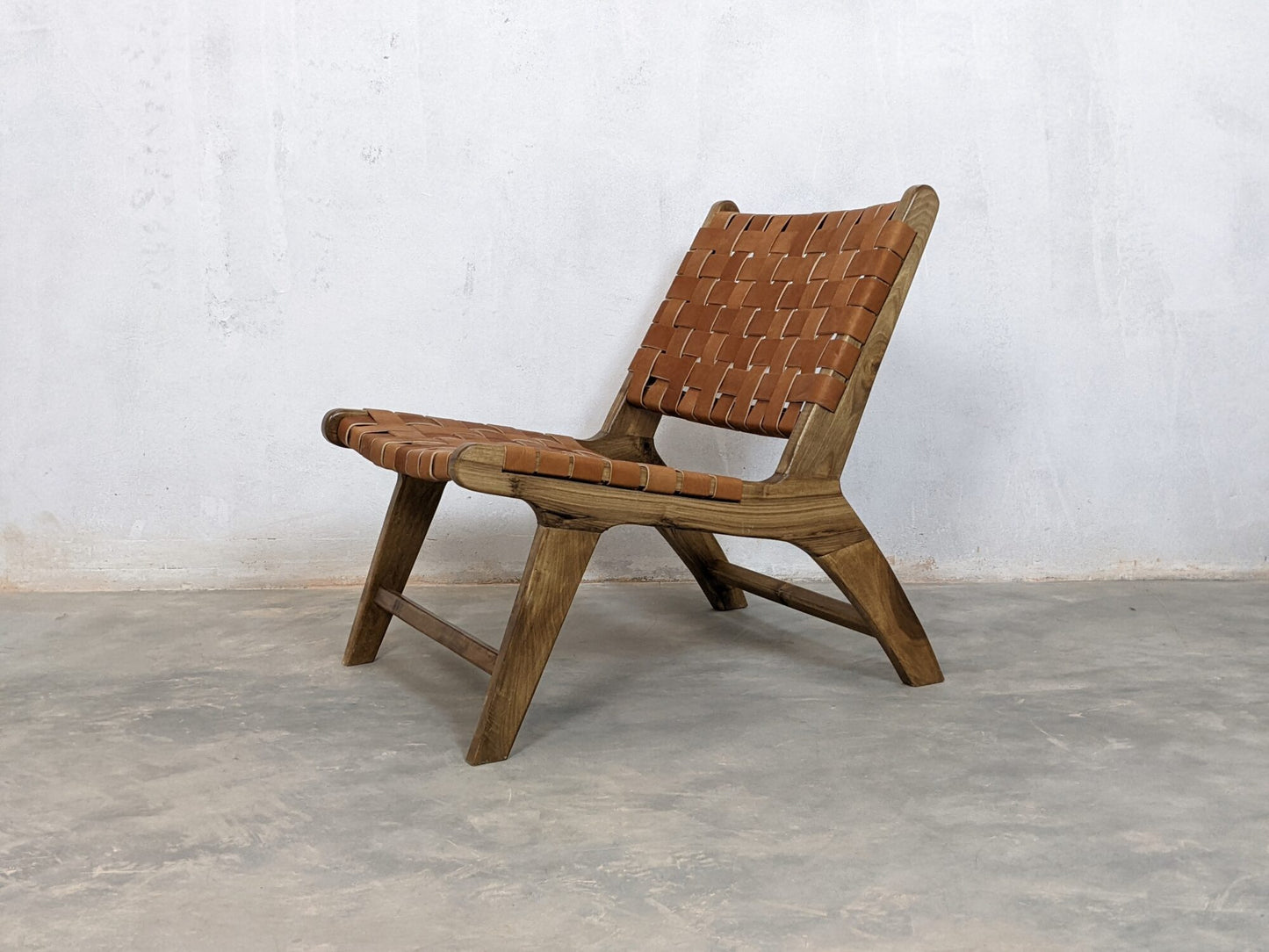 Artisan woven leather chair designed for warm rustic living room interiors 