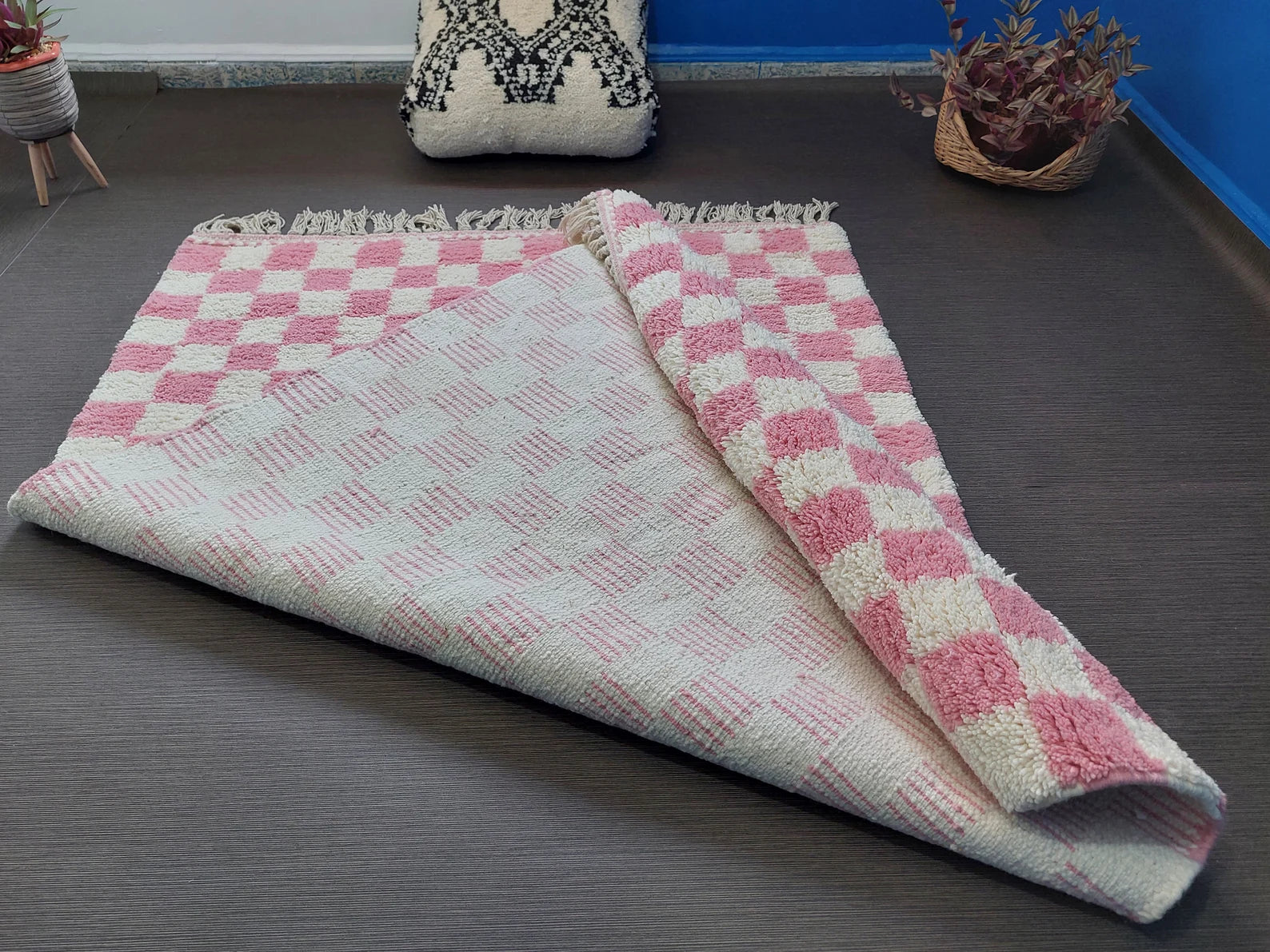 Boho pink checkerboard rug adding playful warmth to modern home styling 