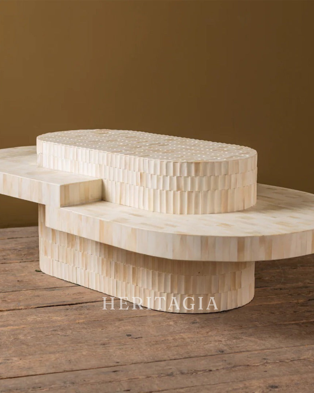 Bone carved coffee table with sculptural layered tiers in soft neutral tones