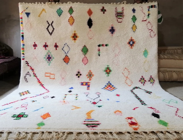  Colorful Moroccan wool rug with abstract symbols on a plush white wool base