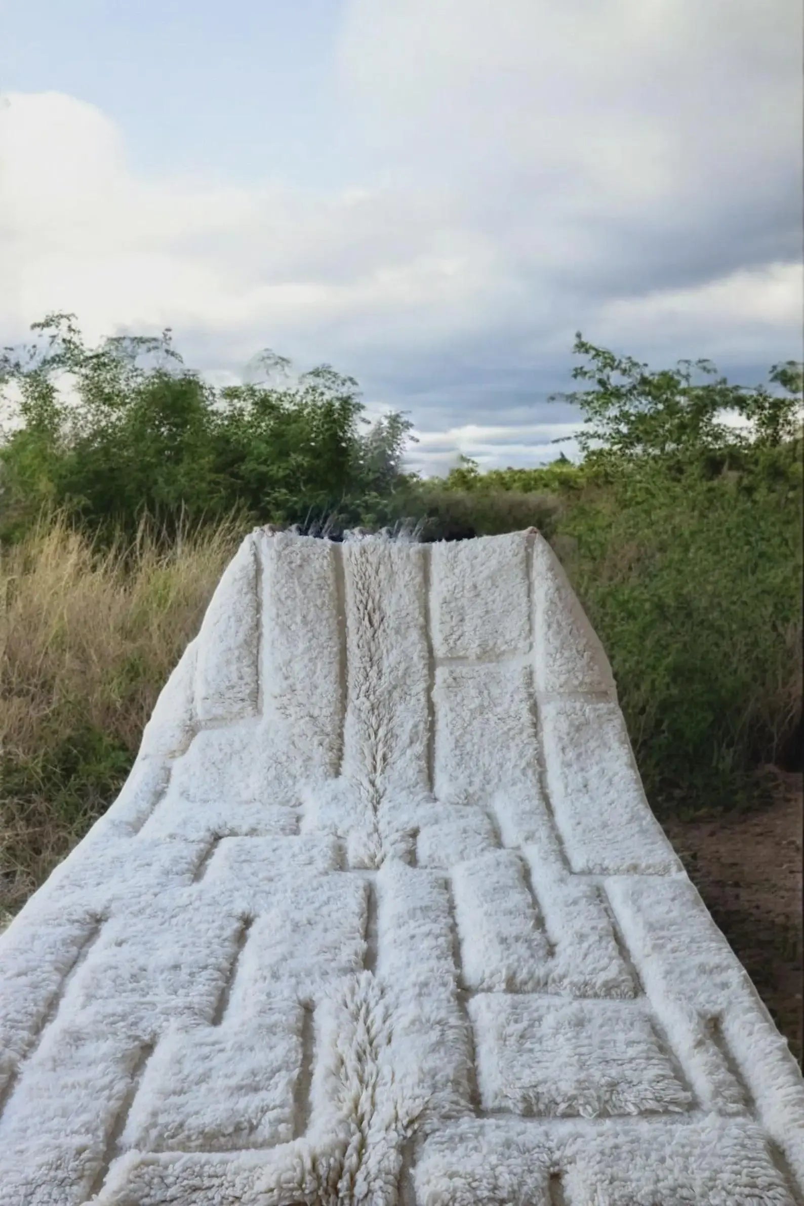 Geometric white wool rug with handmade texture and artisan character