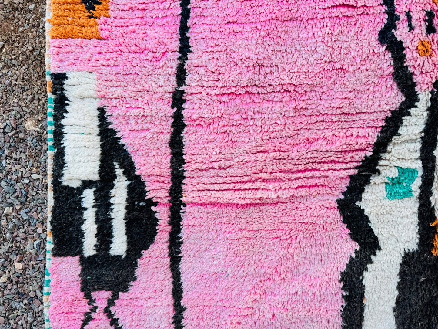 Handmade pink Berber wool area rug featuring abstract artisan patterns