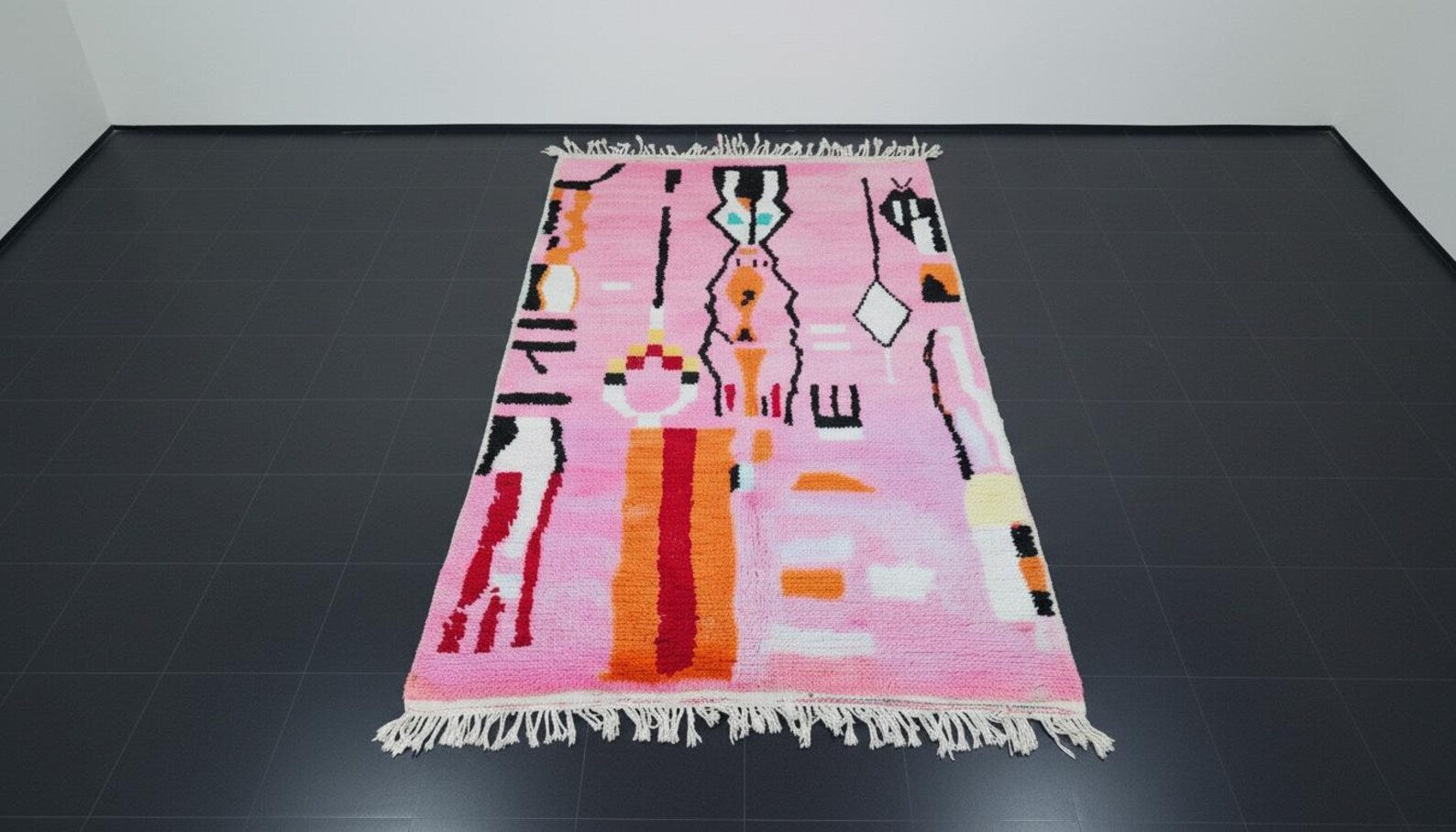 Luxury handmade rug featuring abstract geometric motifs on a pink base