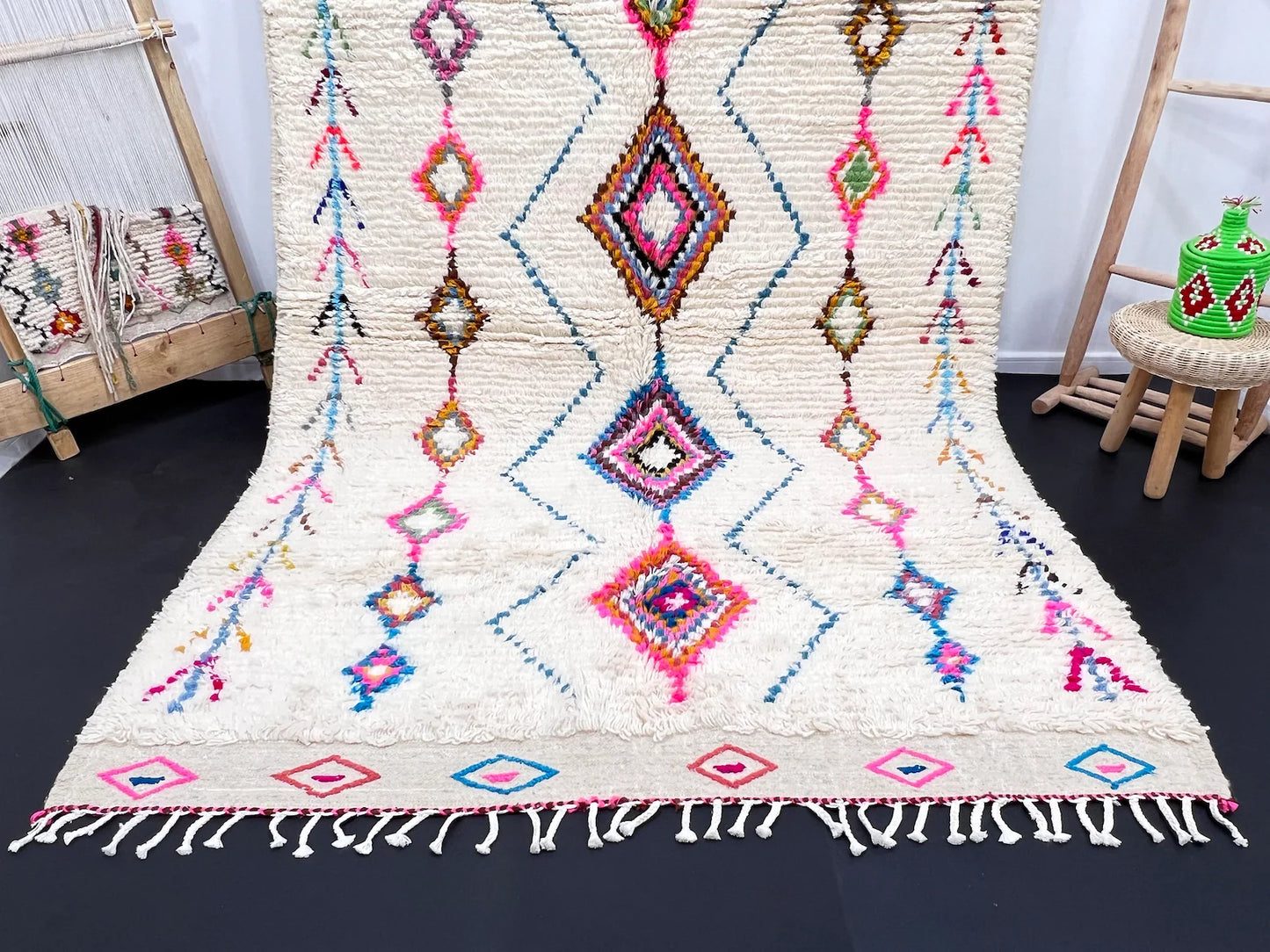 Soft white Berber rug with colorful geometric diamonds styled in bedroom