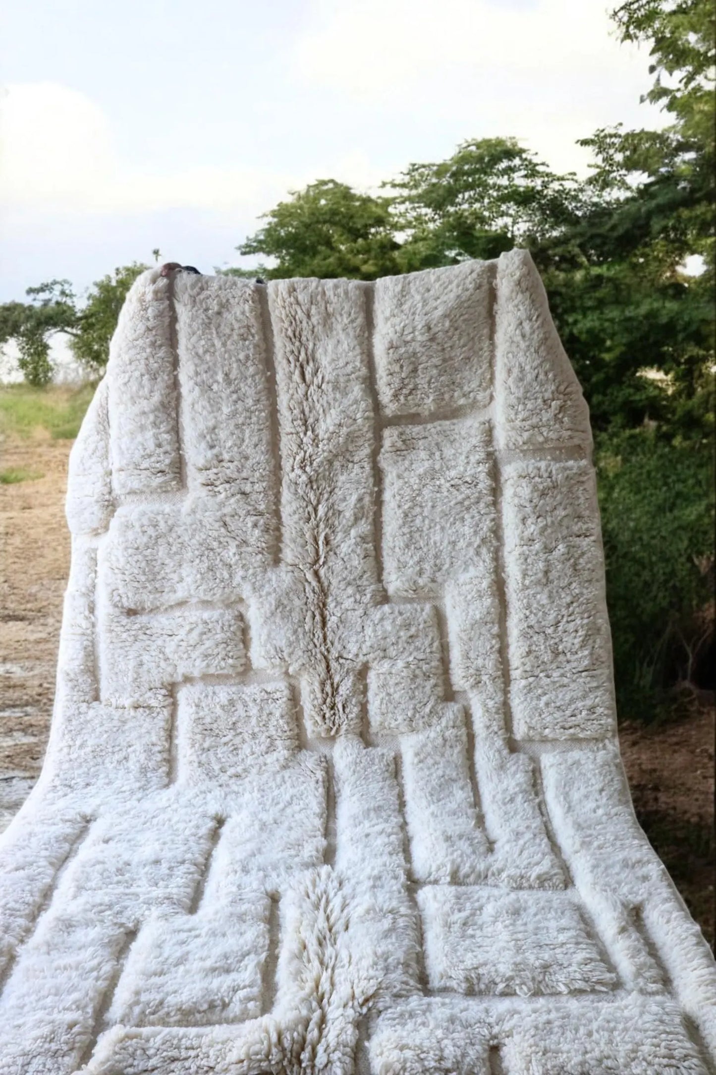 White Beni Ourain rug with textured geometric pattern and plush wool finish