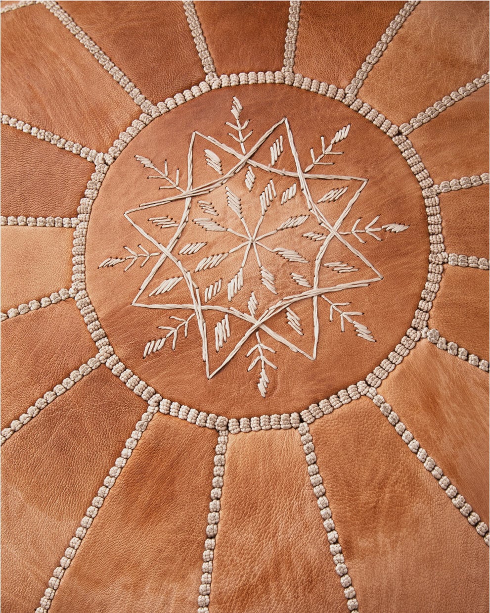 Shared view — hand embroidered cognac pouf detail; example colour and filled styling