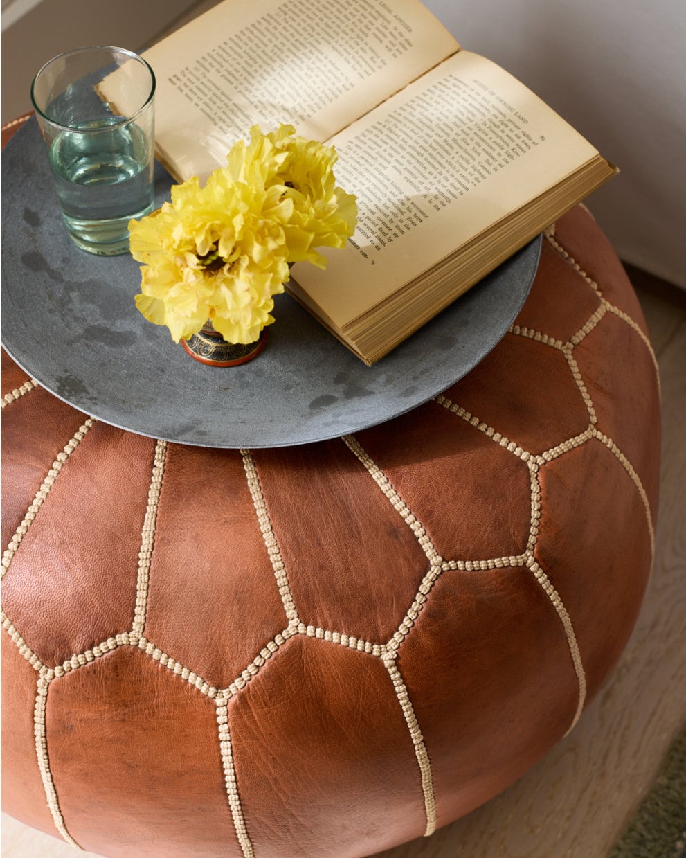 Shared view — cognac pouf styled as a low table; example colour and filled styling